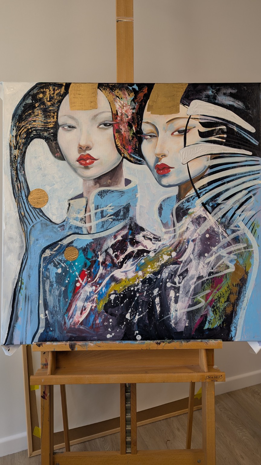 Two female figures in blue and black with gold circular marks